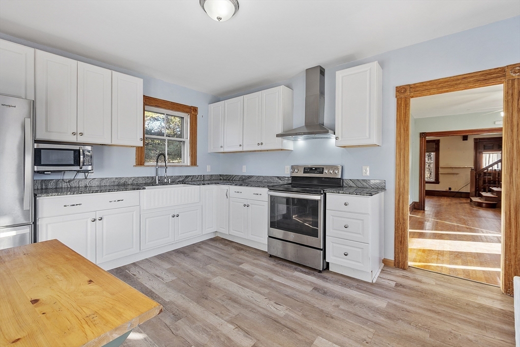 39 Terrace Street Orange, MA 01364 - Photo 6 of 40 a kitchen with stainless steel appliances granite countertop a stove a sink and white cabinets
