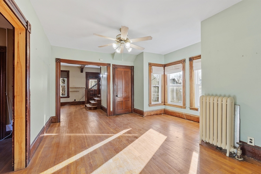 39 Terrace Street Orange, MA 01364 - Photo 10 of 40 a view of a livingroom with wooden floor and ceiling fan