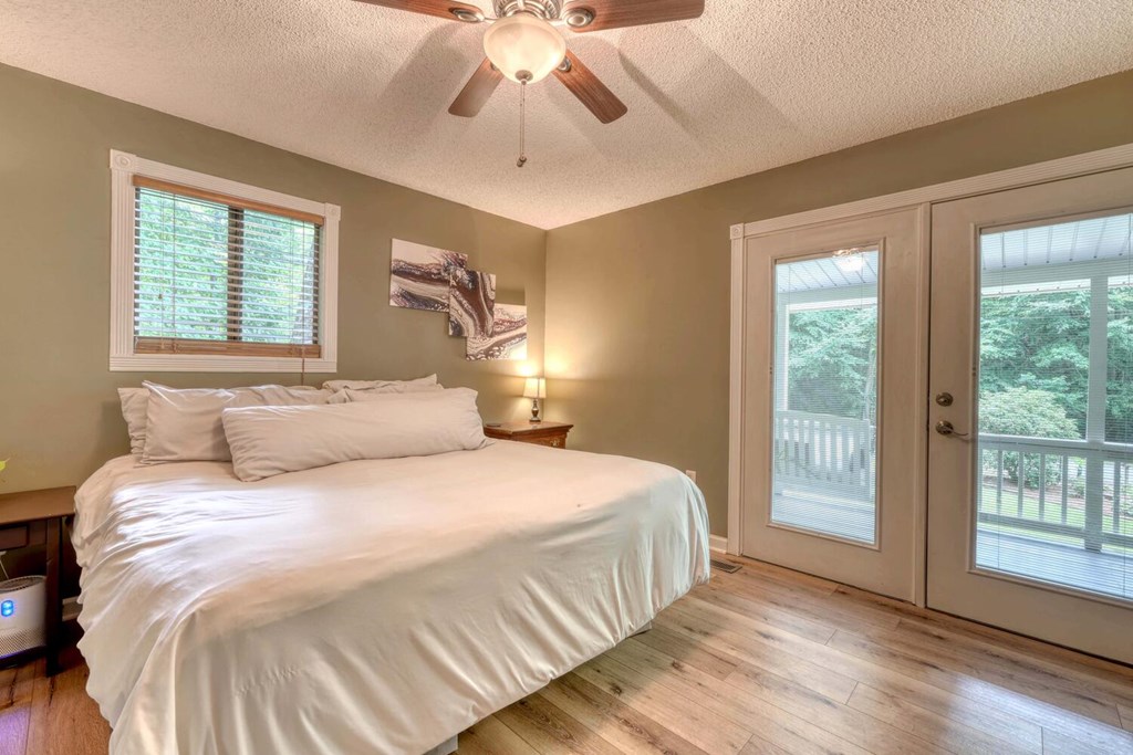 14 Priscilla Lane Murphy, NC 28906 - Photo 13 of 42 a bedroom with a large bed and a chandelier