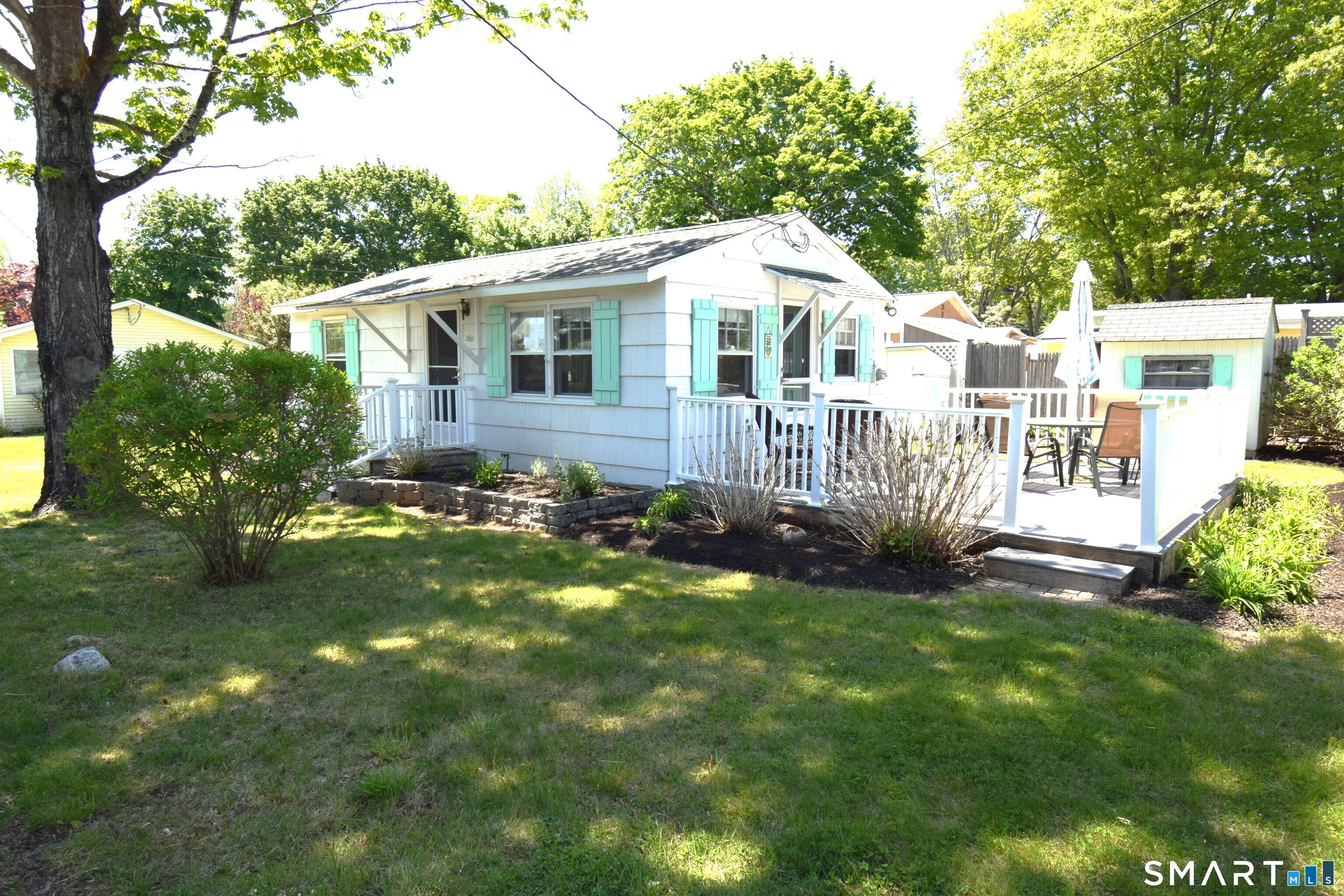 50 East Street Madison, CT 06443 - Photo 1 of 26 a view of a house with a yard and sitting area