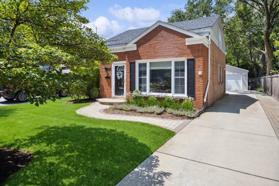 708 Long Road Glenview, IL 60025 - Photo 1 of 23 a front view of a house with a yard and porch