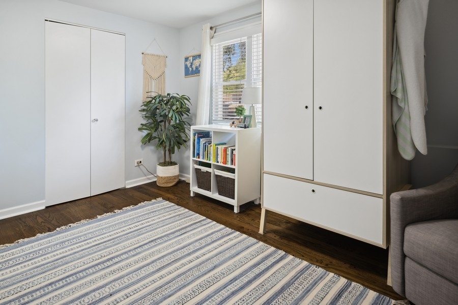 708 Long Road Glenview, IL 60025 - Photo 14 of 23 a room with a bed and a book shelf
