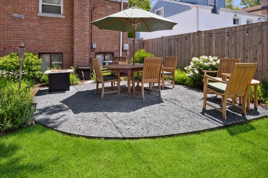 708 Long Road Glenview, IL 60025 - Photo 16 of 23 a view of a backyard with chairs potted plants and a wooden fence