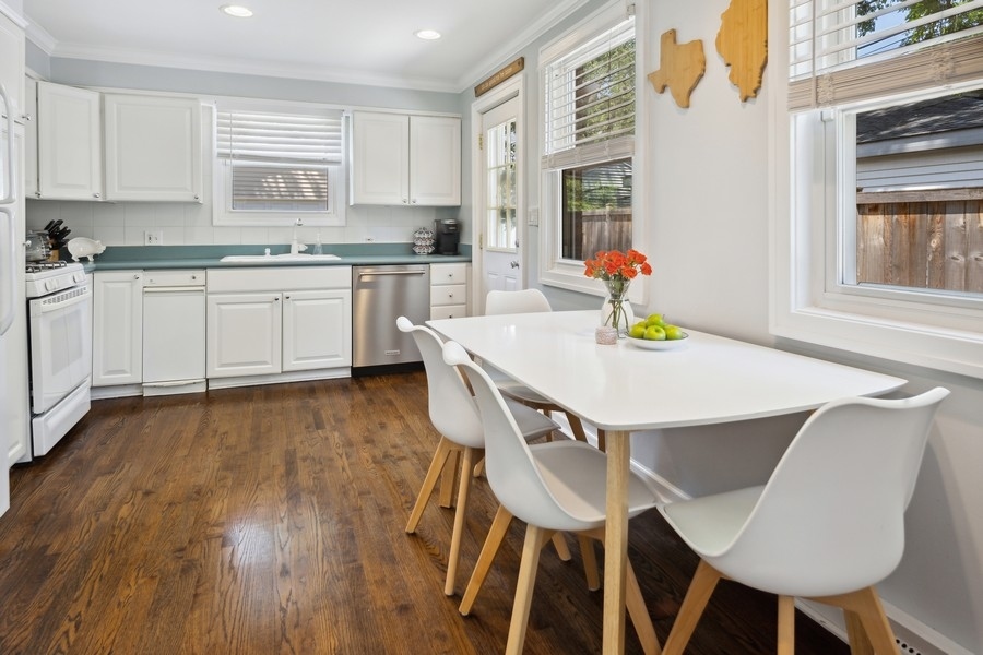 708 Long Road Glenview, IL 60025 - Photo 6 of 23 a kitchen with a table chairs sink and cabinets