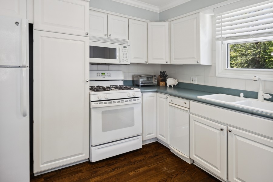 708 Long Road Glenview, IL 60025 - Photo 8 of 23 a kitchen with white cabinets white stainless steel appliances and sink