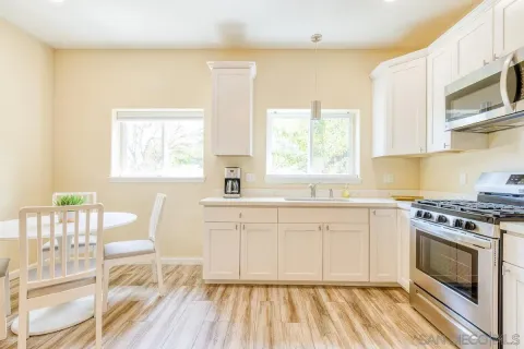 a kitchen with a stove a sink and a microwave