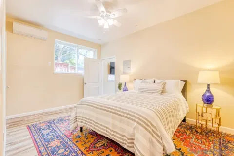 a bedroom with a bed and a lamp