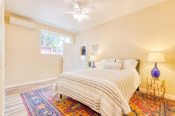 a bedroom with a bed and a lamp