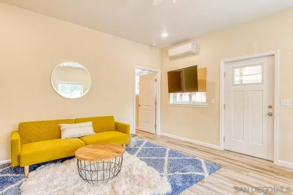 a kitchen with stainless steel appliances a stove a sink refrigerator and a view of living room