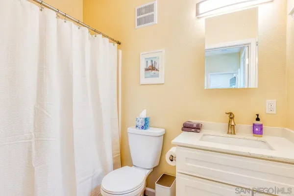 a bathroom with a mirror and a shower