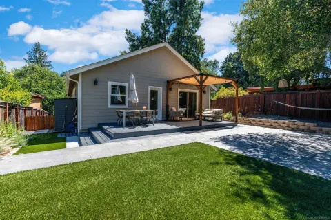 a front view of house with yard and outdoor seating