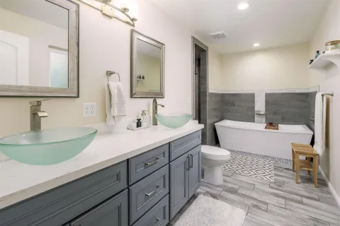 a bathroom with a sink a toilet and a mirror