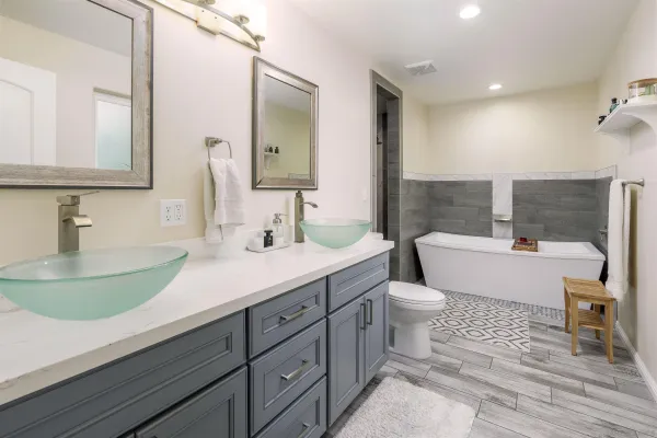 a bathroom with a sink a toilet and a mirror