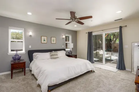 a bedroom with a large bed and a window