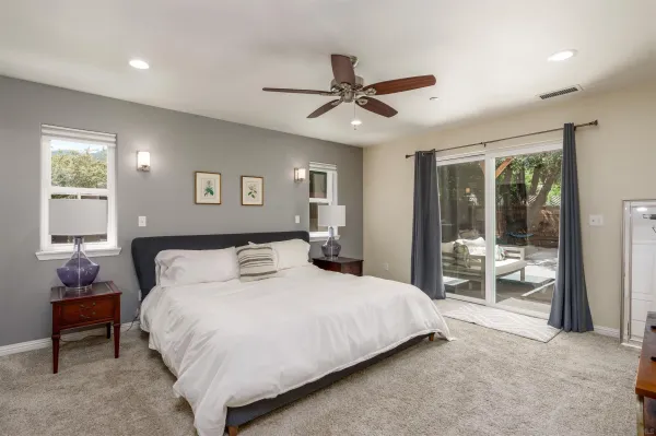 a bedroom with a large bed and a window