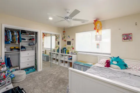 a living room with furniture and dresser