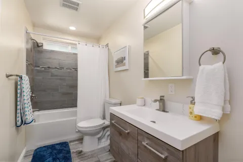 a bathroom with a sink toilet and shower