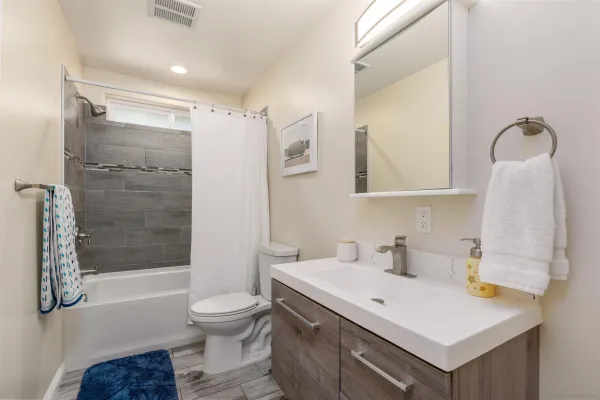 a bathroom with a sink toilet and shower