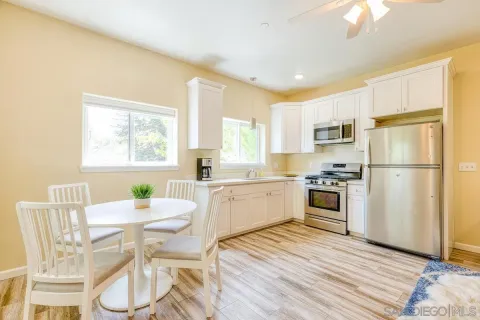 a kitchen with a sink cabinets stainless steel appliances and window