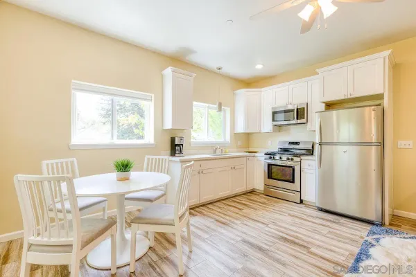 a kitchen with a sink cabinets stainless steel appliances and window