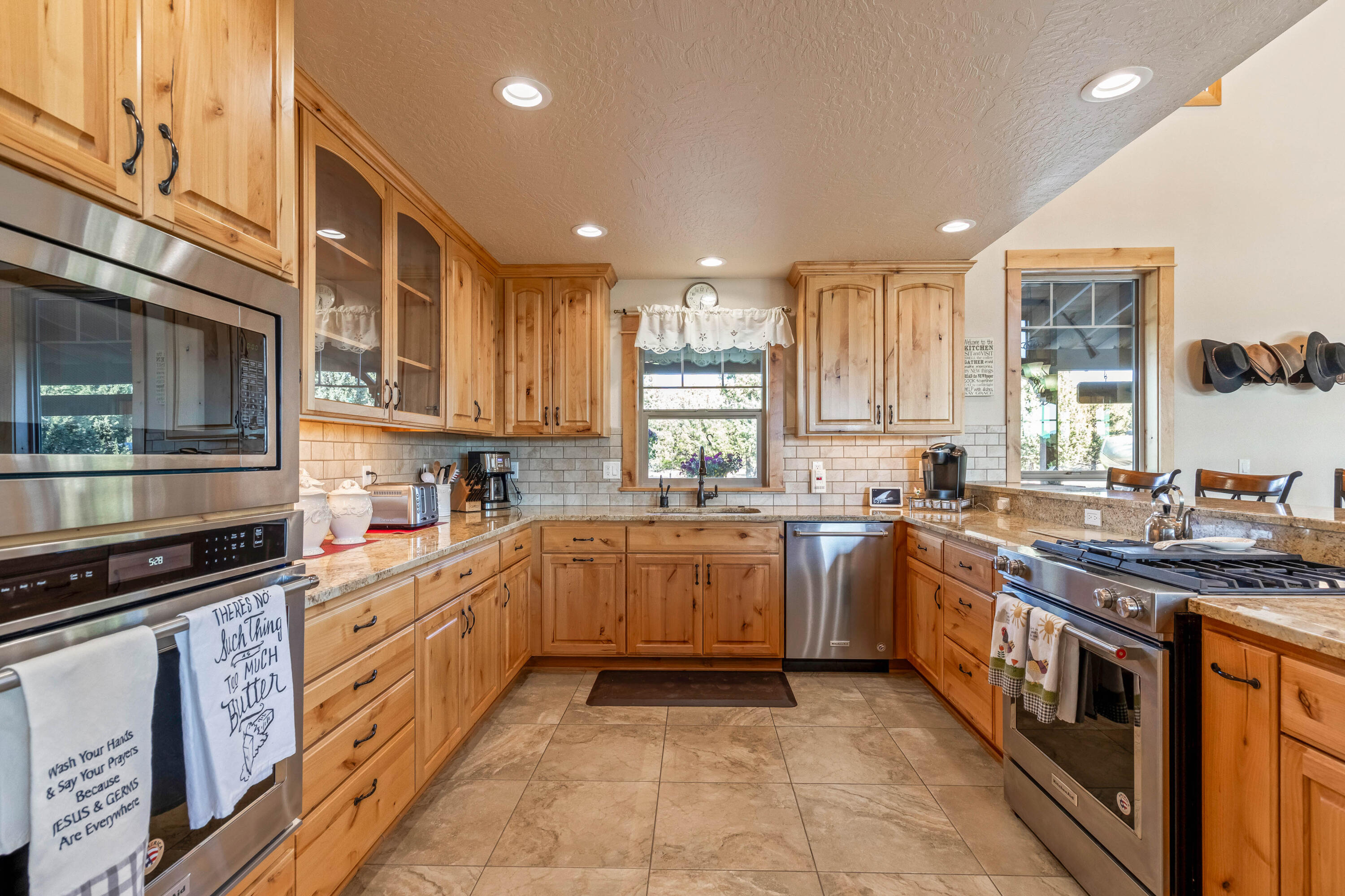 70030 Northwest Hunt Road Sisters, OR 97759 - Photo 8 of 55 a kitchen with stainless steel appliances granite countertop a stove top oven a sink dishwasher and a microwave oven on the blue kitchen countertops