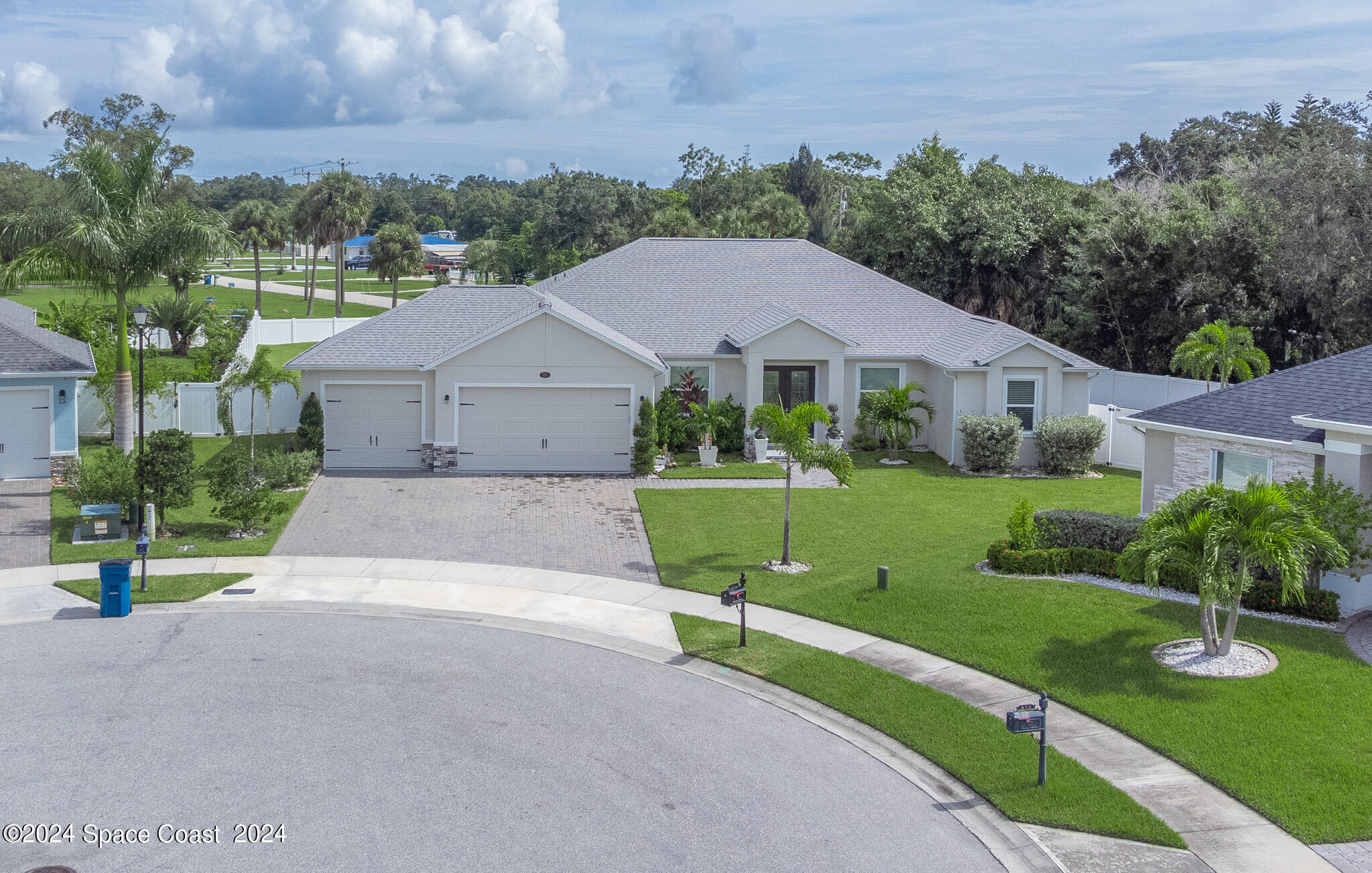 865 Hawks Ridge Court Northeast Palm Bay, FL 32905 - Photo 1 of 47 a aerial view of a house next to a big yard and large trees