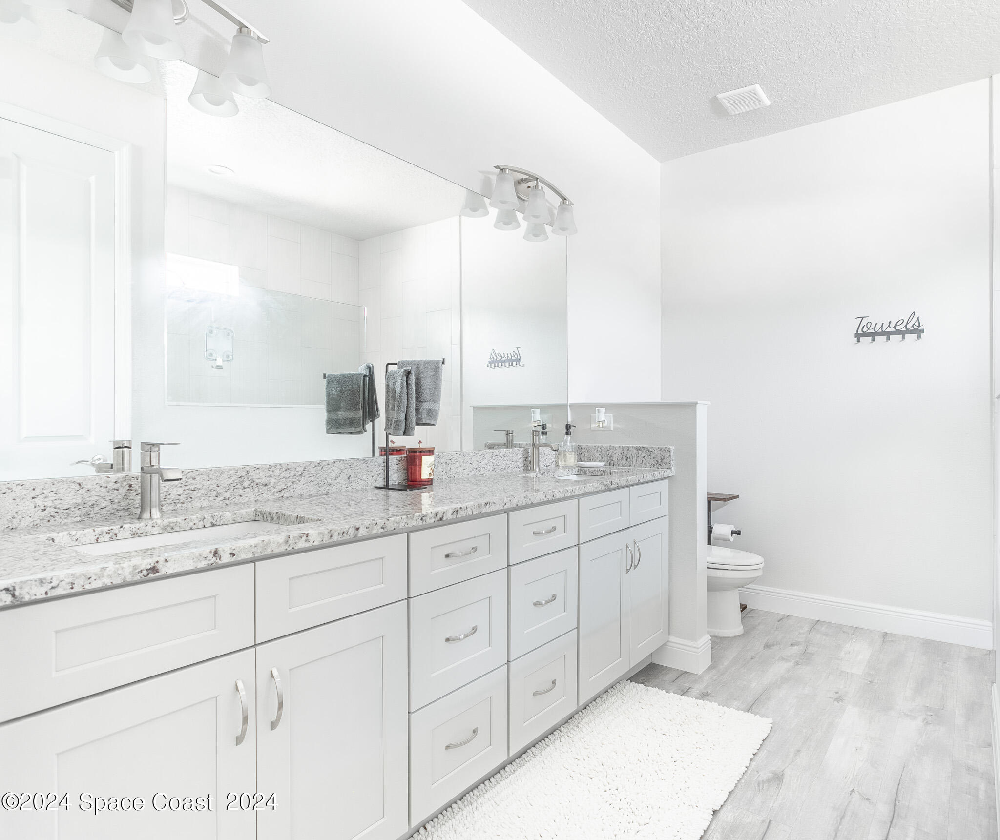 865 Hawks Ridge Court Northeast Palm Bay, FL 32905 - Photo 16 of 47 a bathroom with a granite countertop sink mirror and vanity