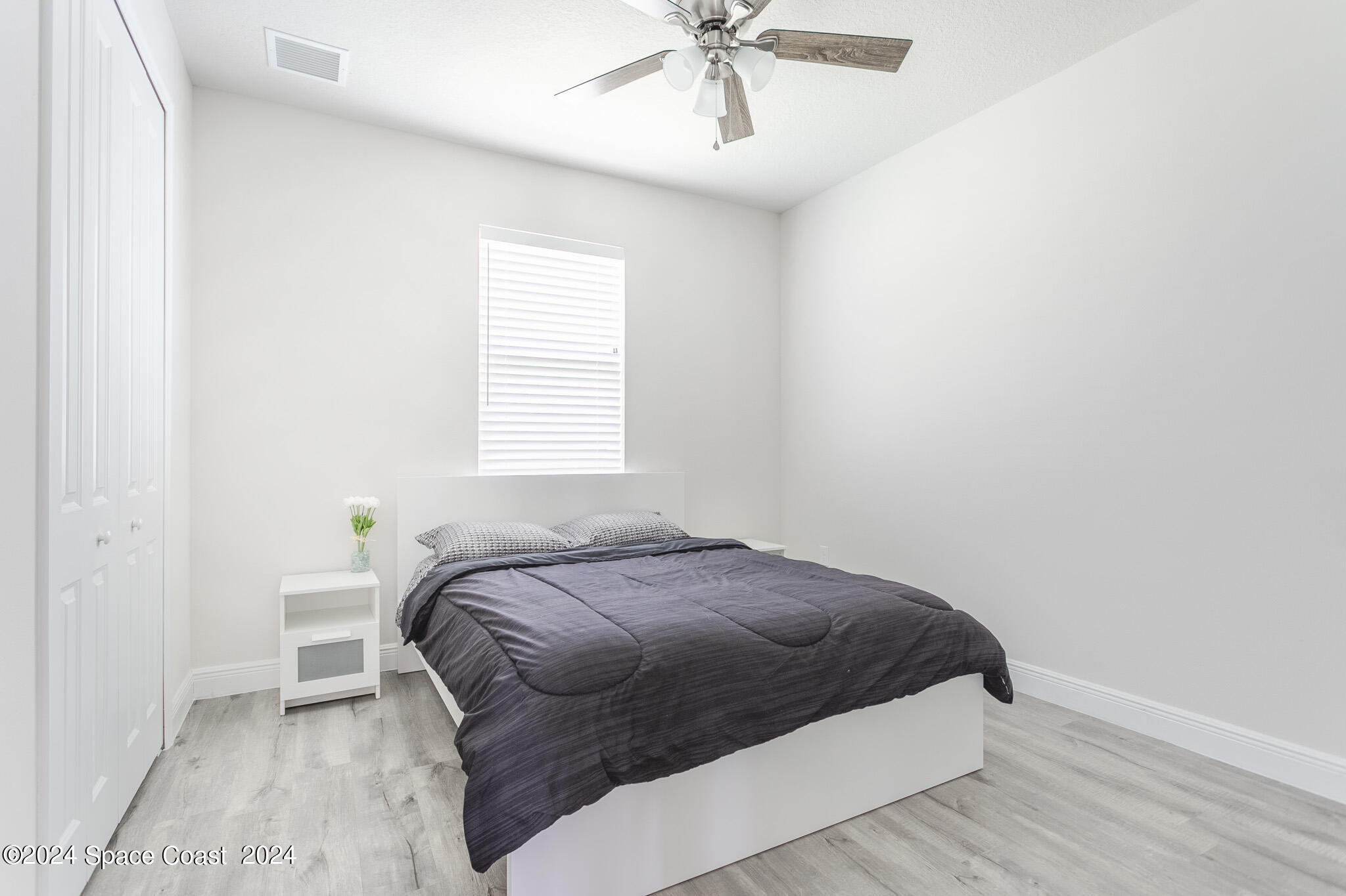 865 Hawks Ridge Court Northeast Palm Bay, FL 32905 - Photo 18 of 47 a bedroom with a bed and window