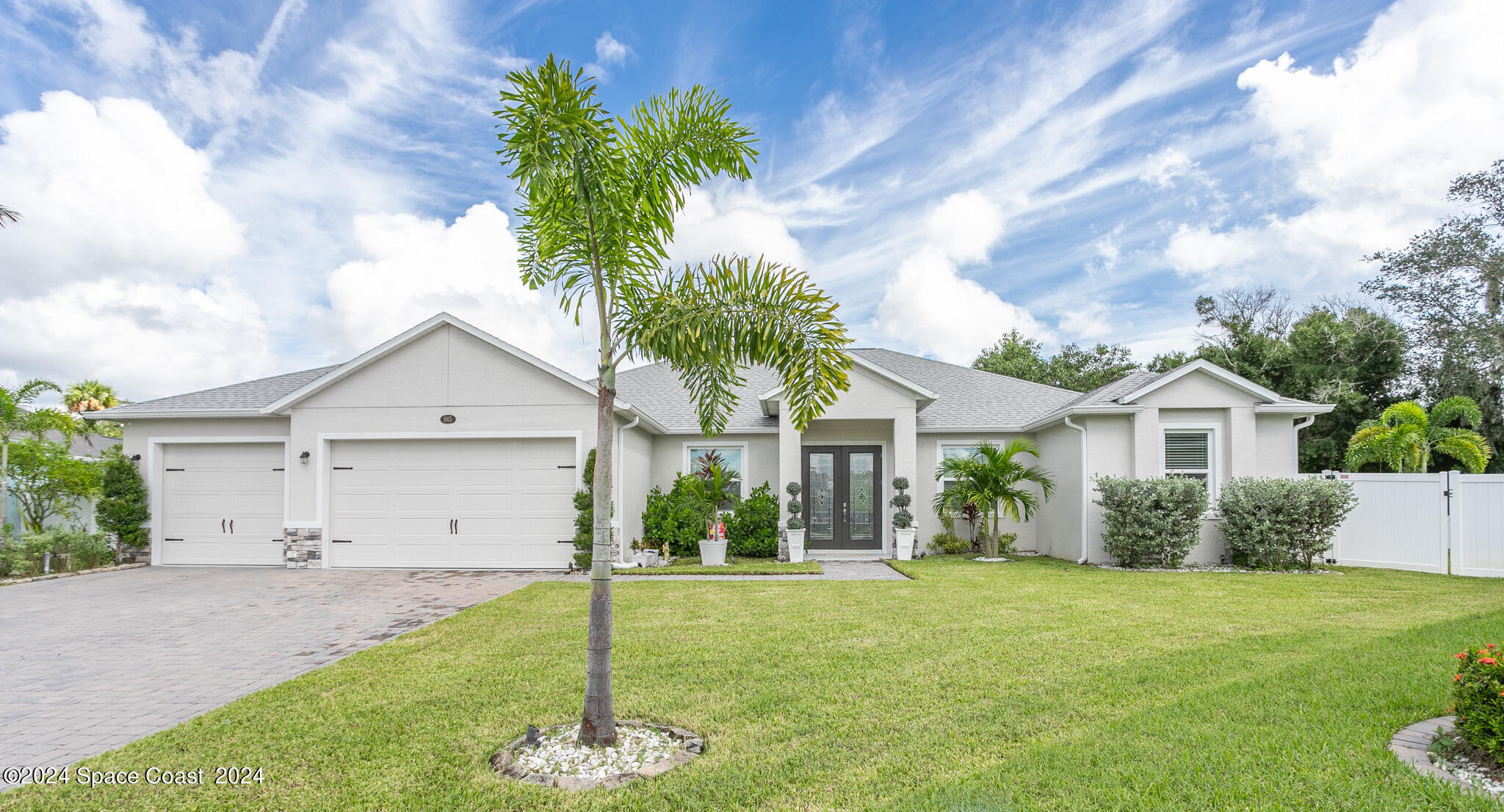 865 Hawks Ridge Court Northeast Palm Bay, FL 32905 - Photo 42 of 47 a front view of house with a garden and yard