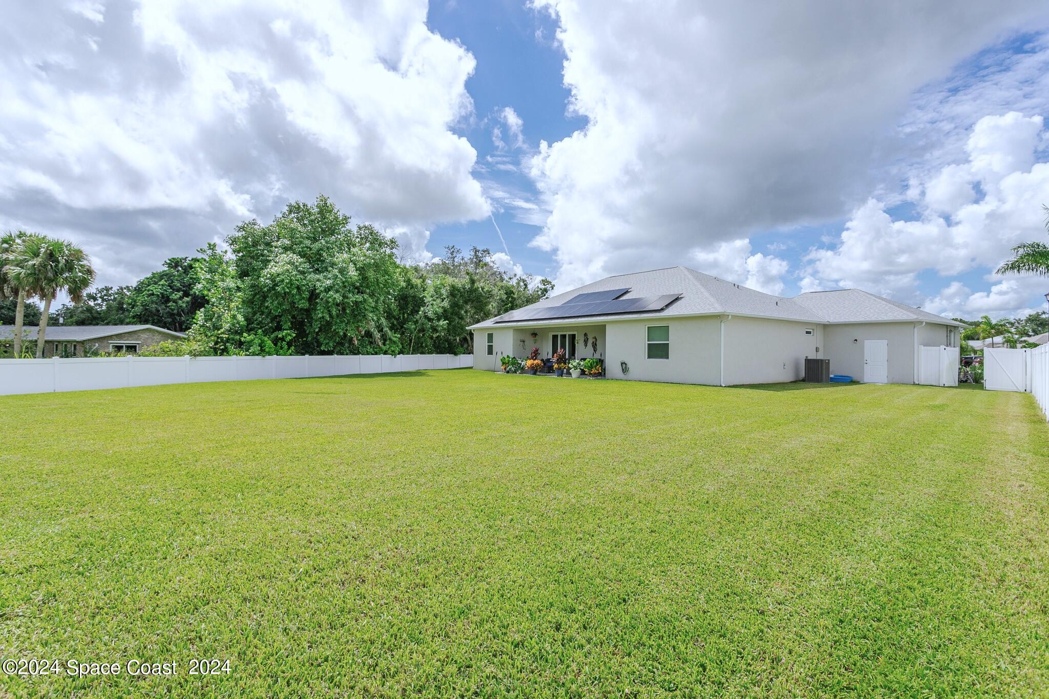 865 Hawks Ridge Court Northeast Palm Bay, FL 32905 - Photo 44 of 47 a front view of house with yard and entertaining space