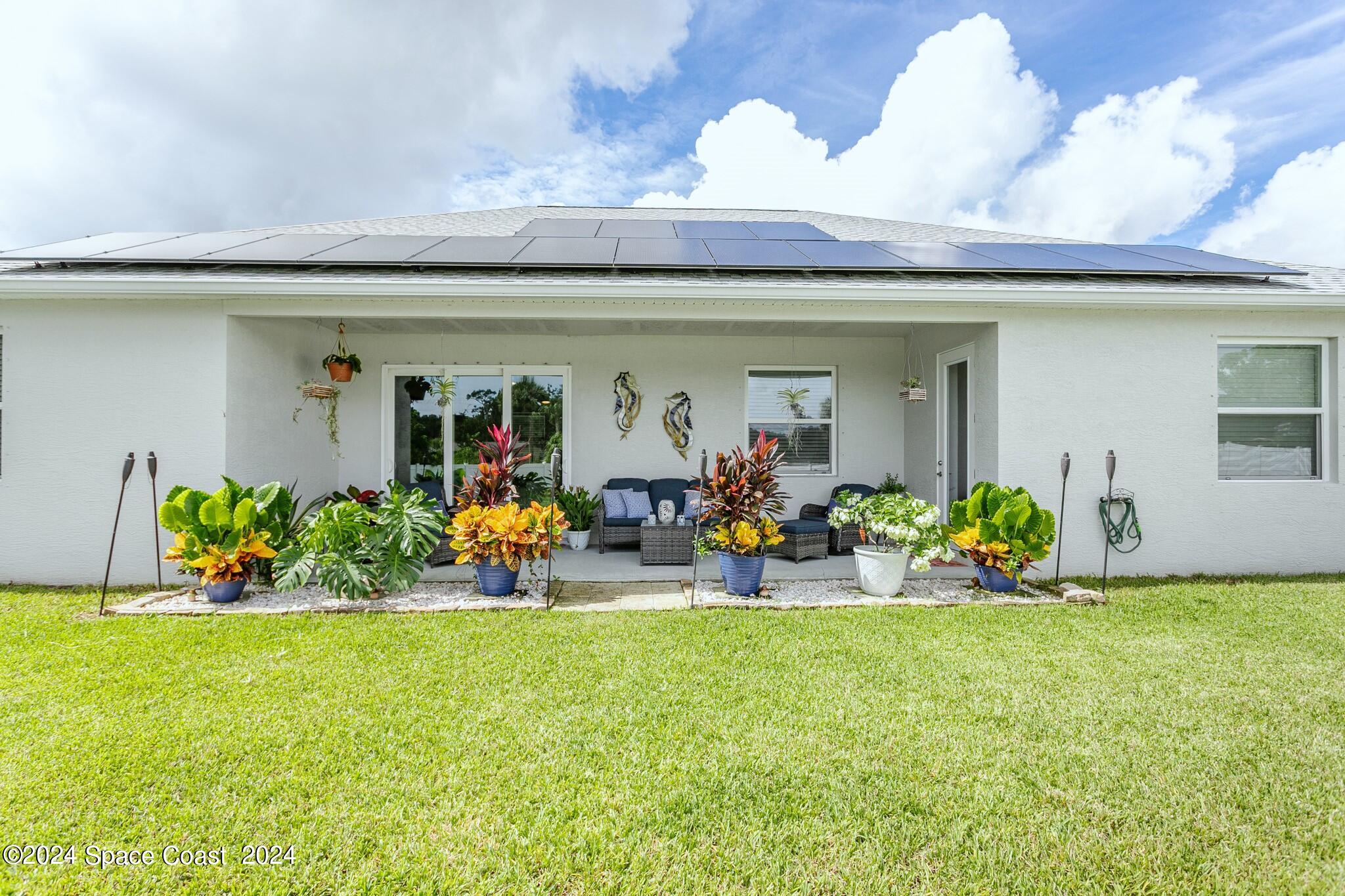 865 Hawks Ridge Court Northeast Palm Bay, FL 32905 - Photo 46 of 47 a view of a garage with a bike and chairs