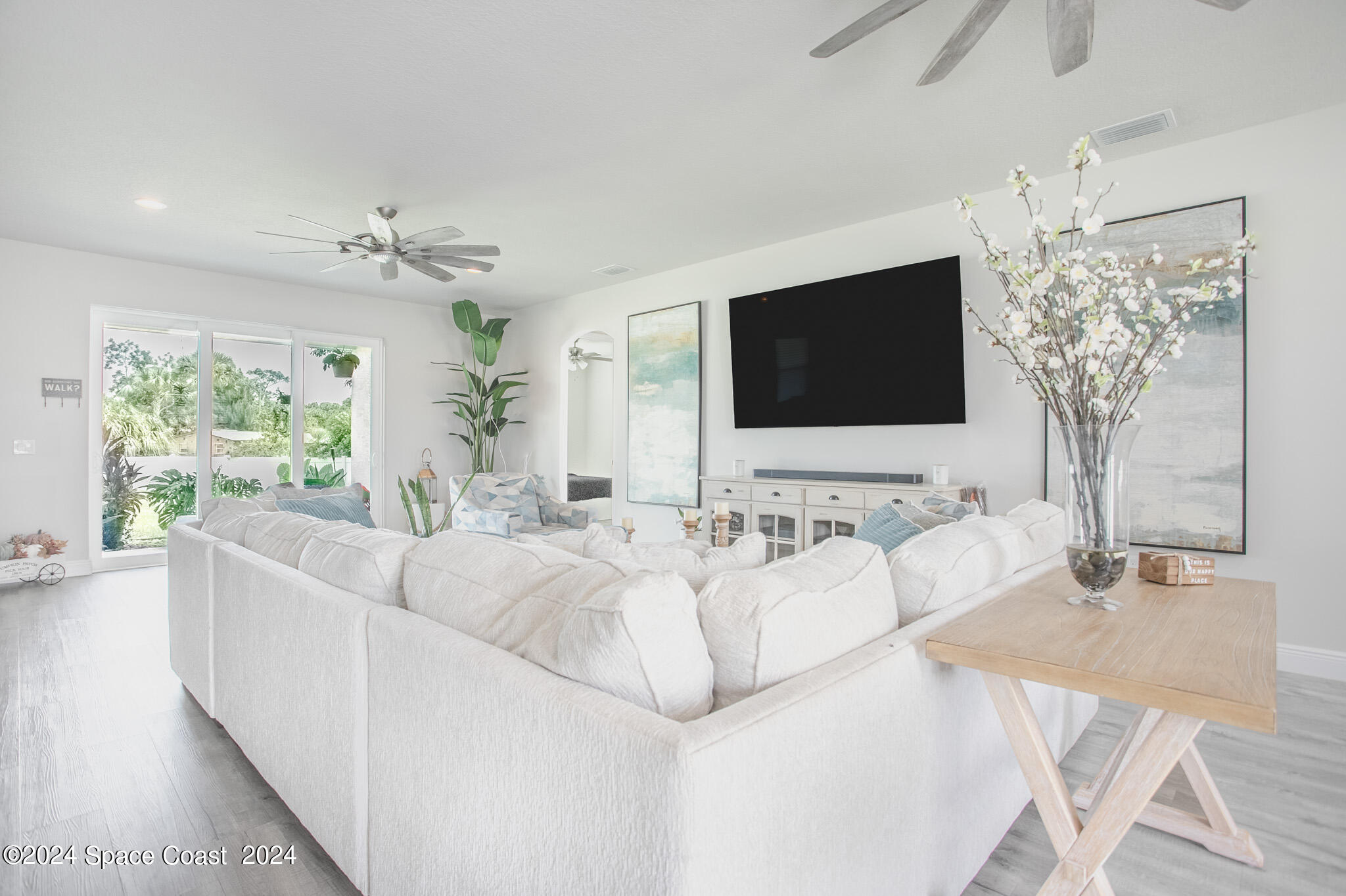 865 Hawks Ridge Court Northeast Palm Bay, FL 32905 - Photo 7 of 47 a living room with furniture and a flat screen tv