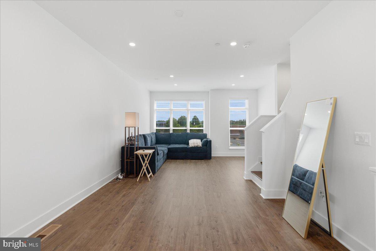 2018 Tysons Ridgeline Road Falls Church, VA 22043 - Photo 31 of 35 a living room with furniture and a wooden floor