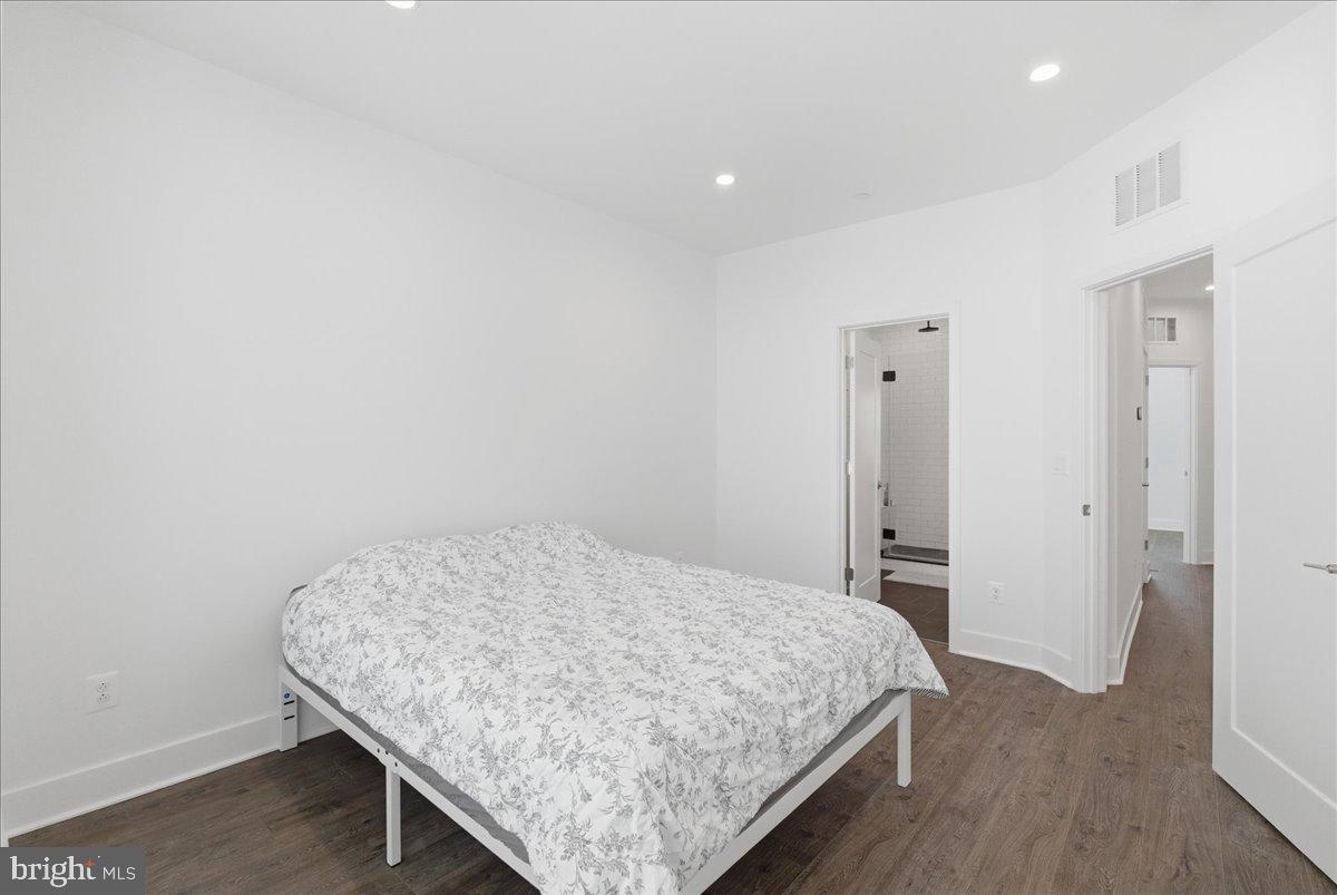 2018 Tysons Ridgeline Road Falls Church, VA 22043 - Photo 34 of 35 a room with a bed and wooden floor