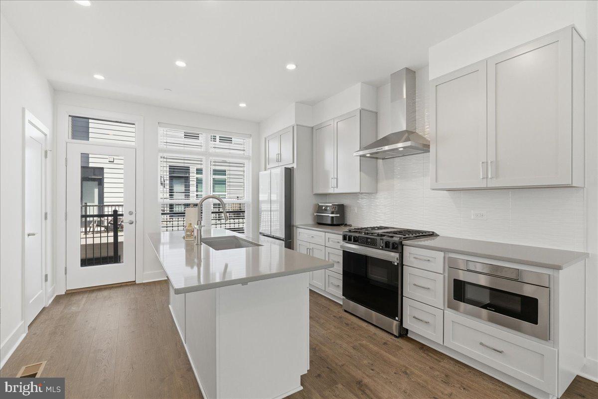 2018 Tysons Ridgeline Road Falls Church, VA 22043 - Photo 6 of 35 a kitchen with stainless steel appliances granite countertop a stove and a refrigerator