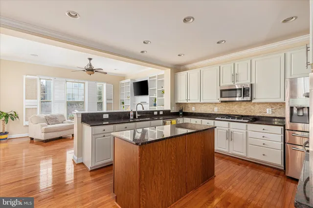 a kitchen with stainless steel appliances granite countertop a stove and a refrigerator