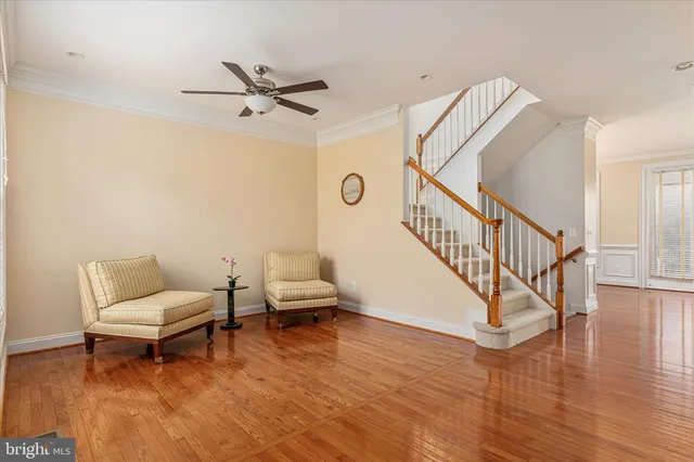 a view of an entryway wooden floor and a living room view