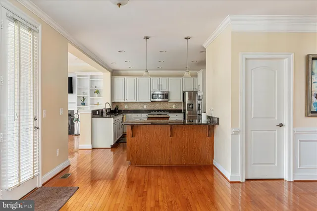a kitchen with stainless steel appliances granite countertop a stove and a sink