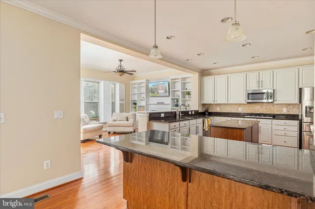 a kitchen with stainless steel appliances and white cabinets