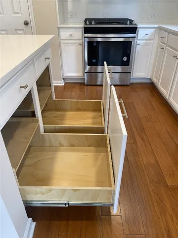 a utility room with wooden floor washer and dryer