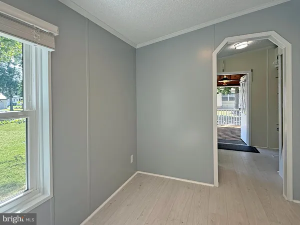 an empty room with windows and entrance