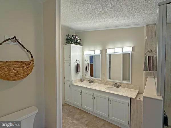 a bathroom with a double vanity sink and a mirror