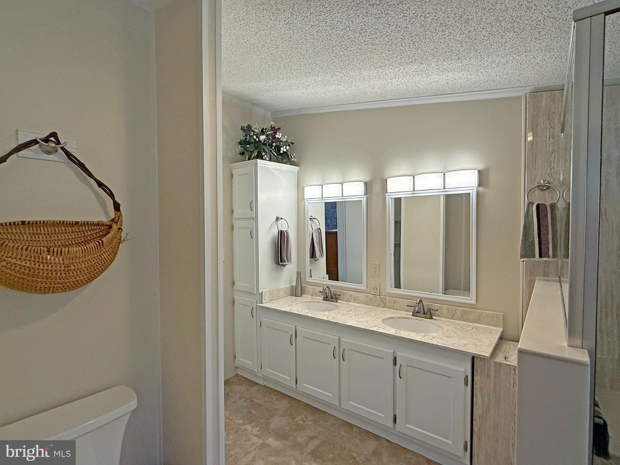 33280 Sassafras Court Ocean View, DE 19970 - Photo 23 of 45 a bathroom with a double vanity sink and a mirror