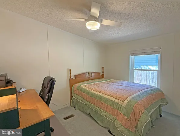 a bedroom with a bed a desk and chair