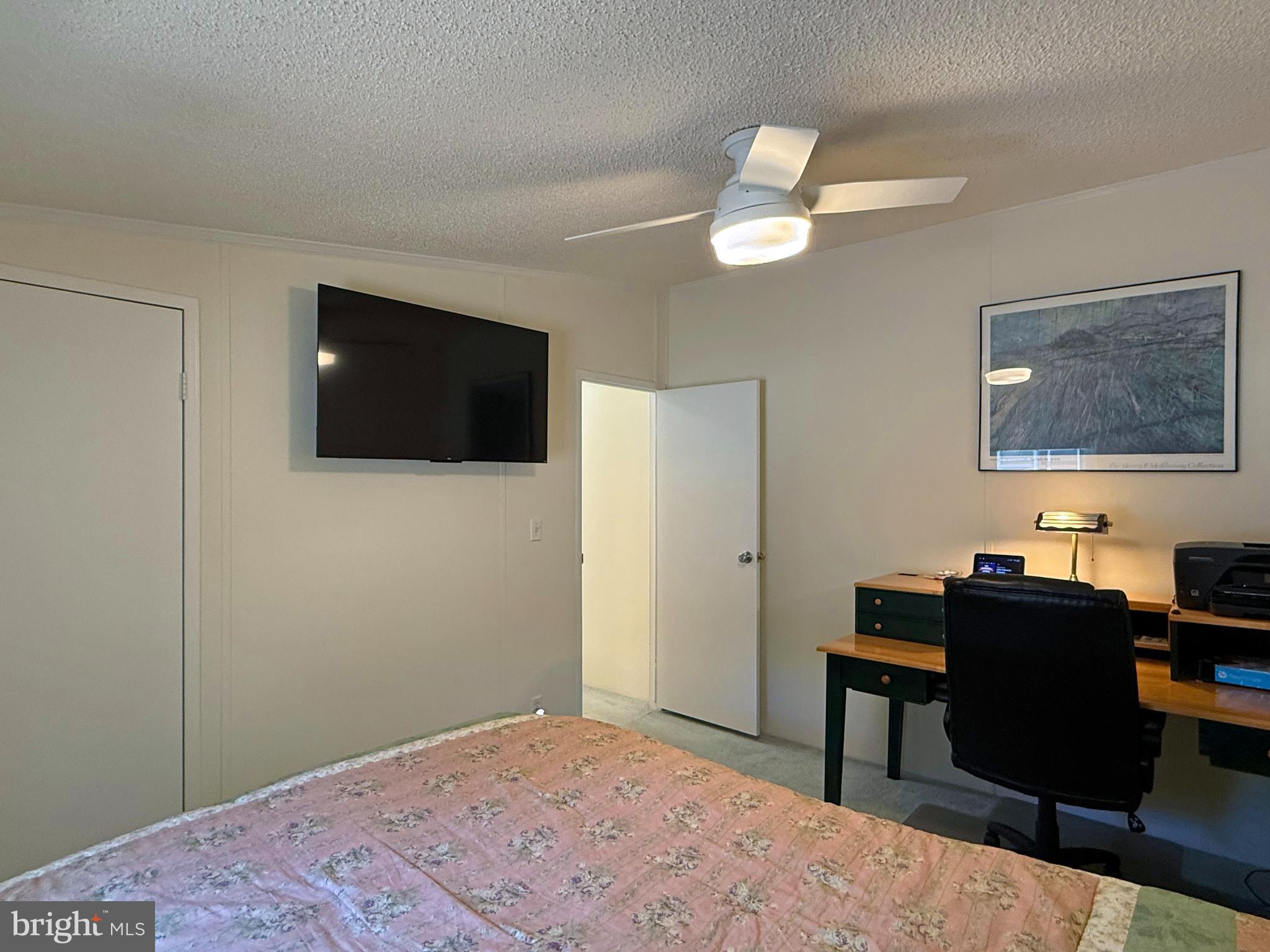 33280 Sassafras Court Ocean View, DE 19970 - Photo 25 of 45 a bedroom with a bed and a flat screen tv