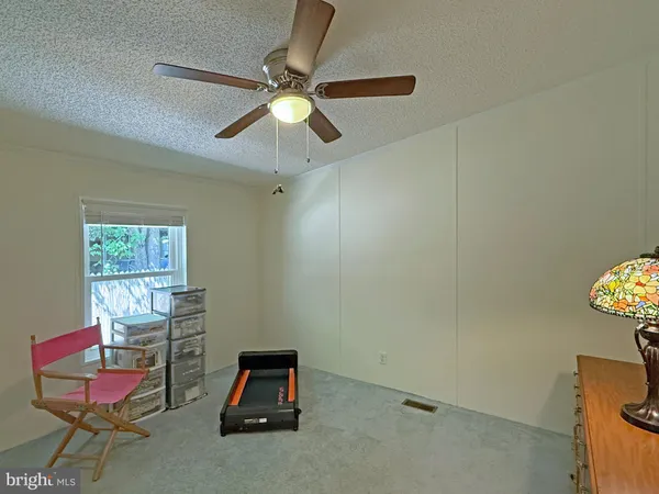 a room with a window and ceiling fan