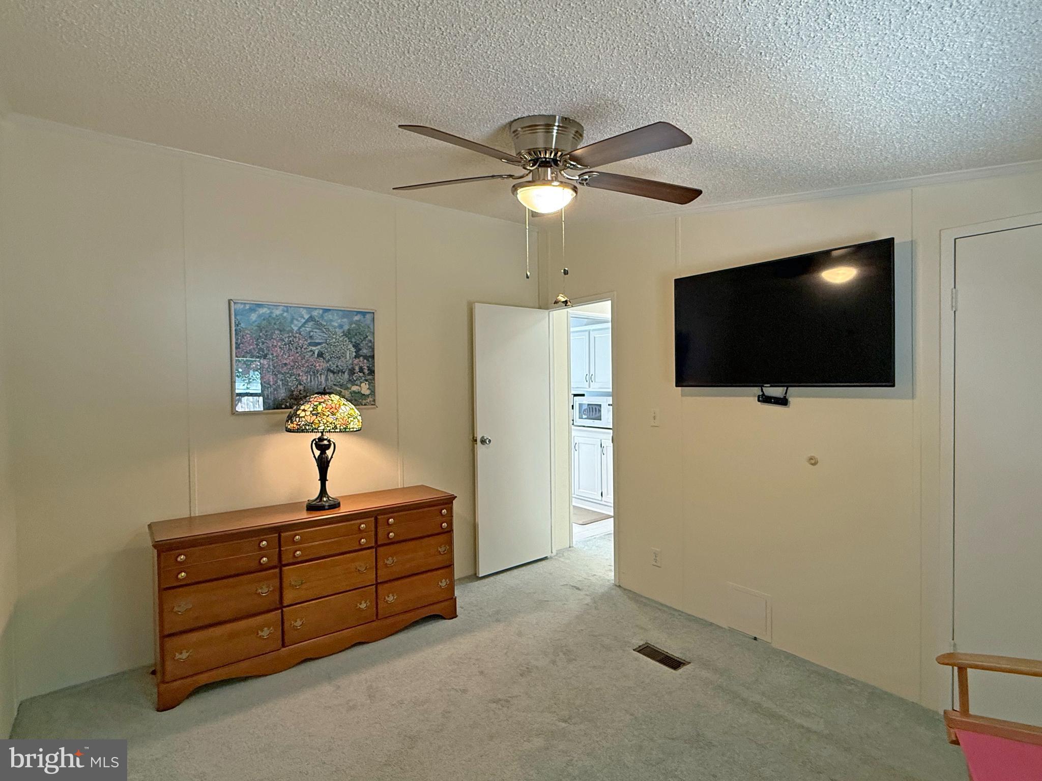 33280 Sassafras Court Ocean View, DE 19970 - Photo 27 of 45 a living room with furniture and a flat screen tv
