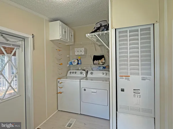 a view of storage and utility room with washer and dryer