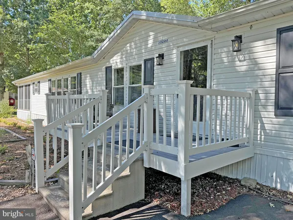 a view of wooden house with a small yard