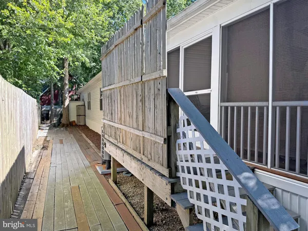 a view of balcony with wooden floor and fence